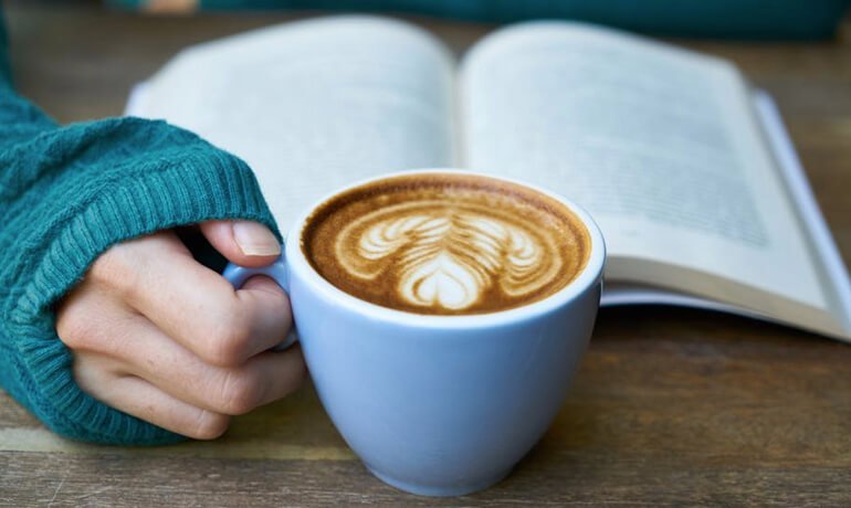 Cup of coffee and book