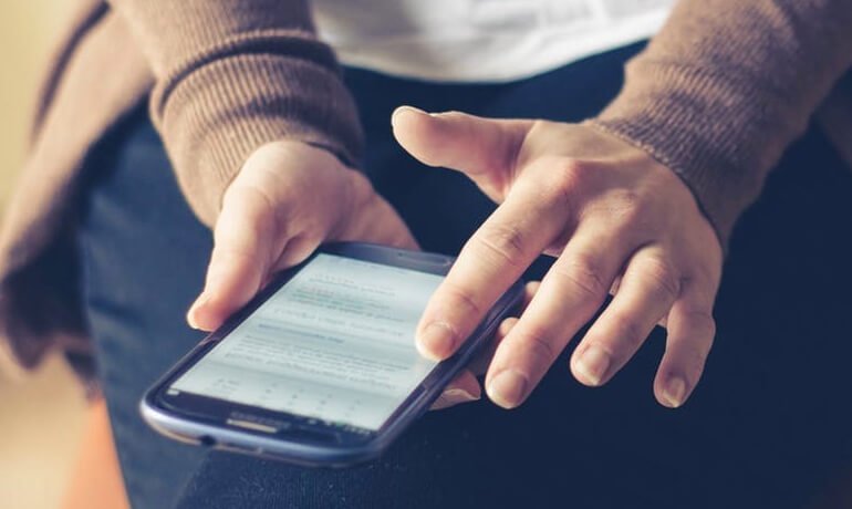 Holding a black phone