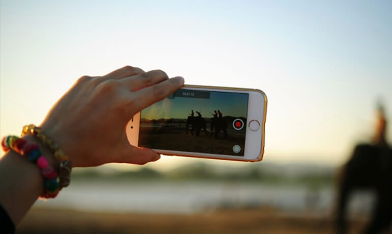 Holding a camera phone to take photos