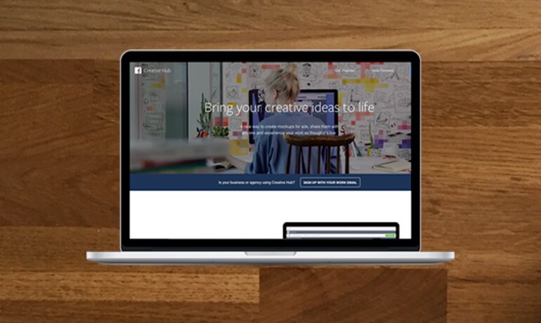 Laptop with wood background and Facebook