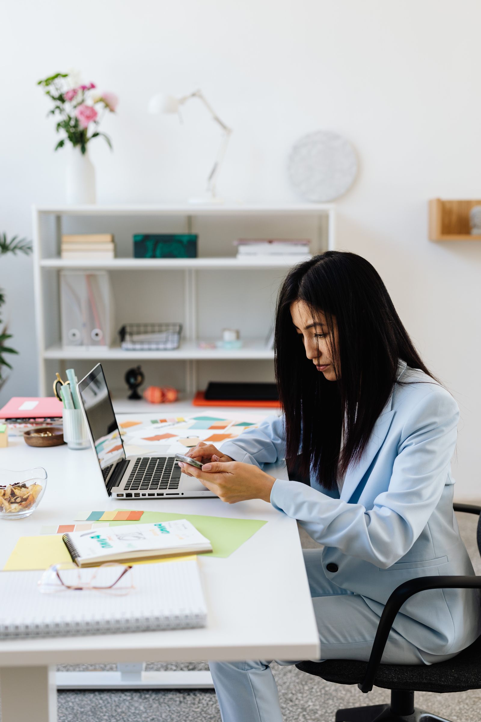 Business professional using company email hosting on laptop and phone